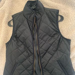 black quilted vest with gold detailing and pockets